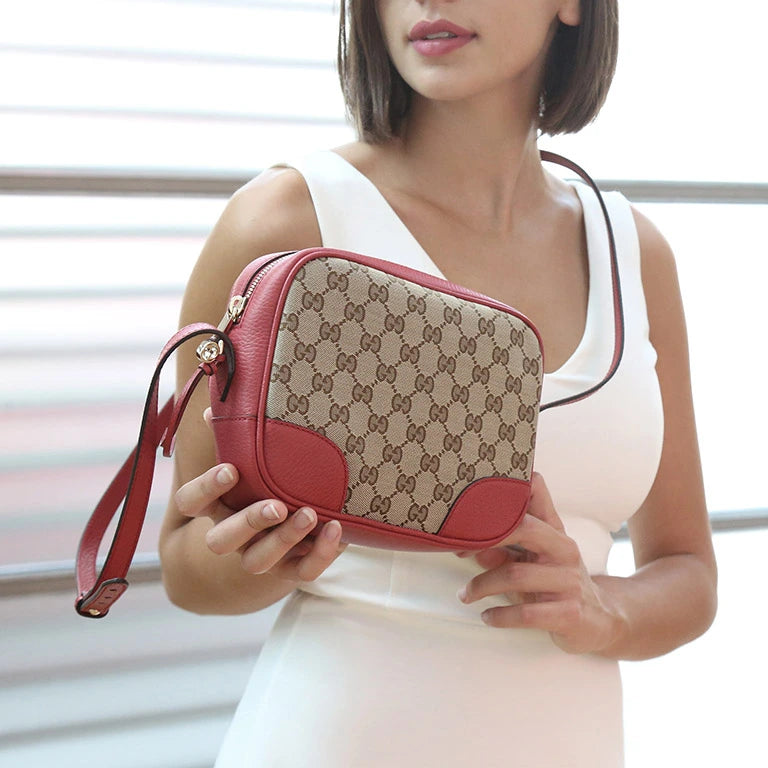 Stylish women's handbags collection featuring a red and patterned handbag held by a model in a white dress.