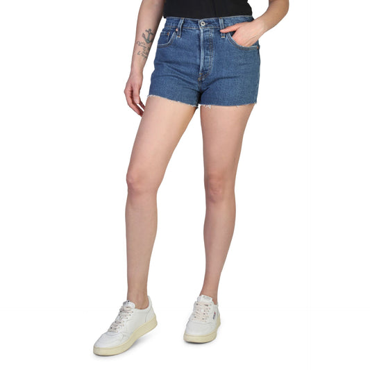 Levis women's shorts in blue denim worn by a woman, casual summer outfit with white sneakers.