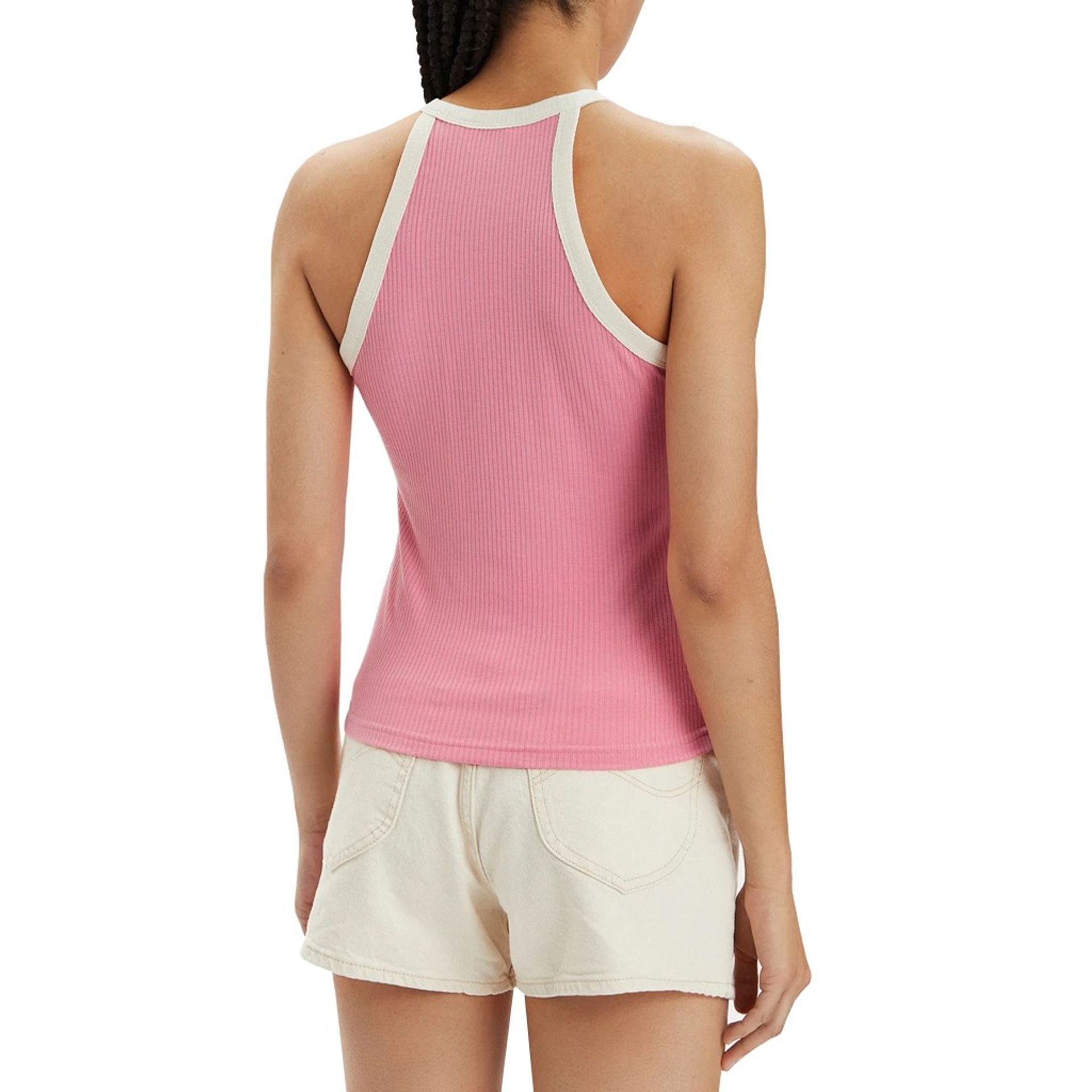 Back view of a woman wearing a pink ribbed top with white trim, showcasing women's Lee tops style.