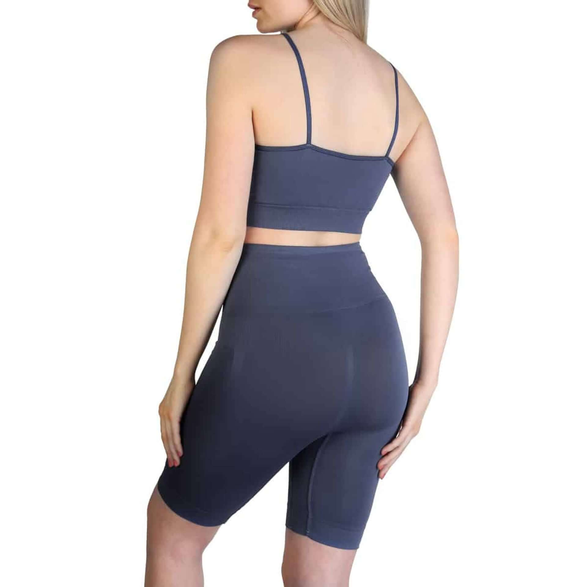 Woman wearing Bodyboo Shaping underwear, showing back view of shaping shorts and fitted top in gray.