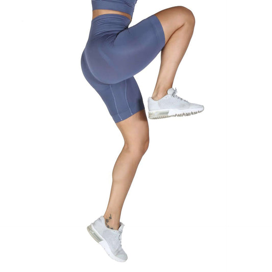 Woman wearing Bodyboo Shaping underwear, elastane and polyamide shaping shorts, exercising in stylish activewear.