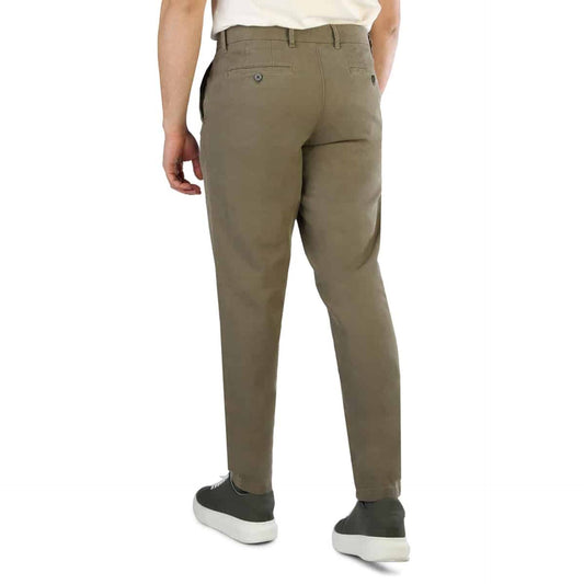 Back view of a man wearing Tommy Hilfiger men's trousers in a light brown color, paired with casual sneakers.